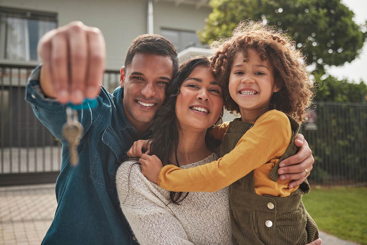 Happy family, portrait and real estate with keys in property, investment or new home together